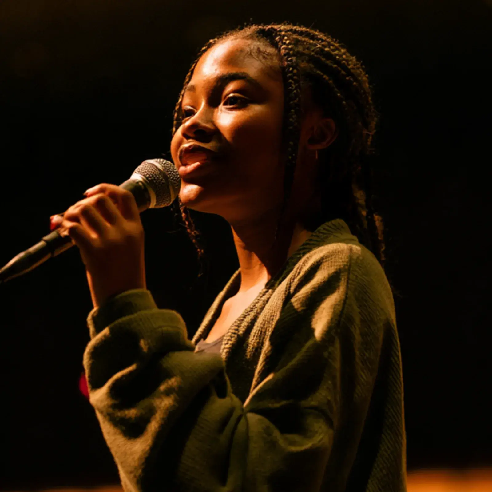 A student presenting into a microphone